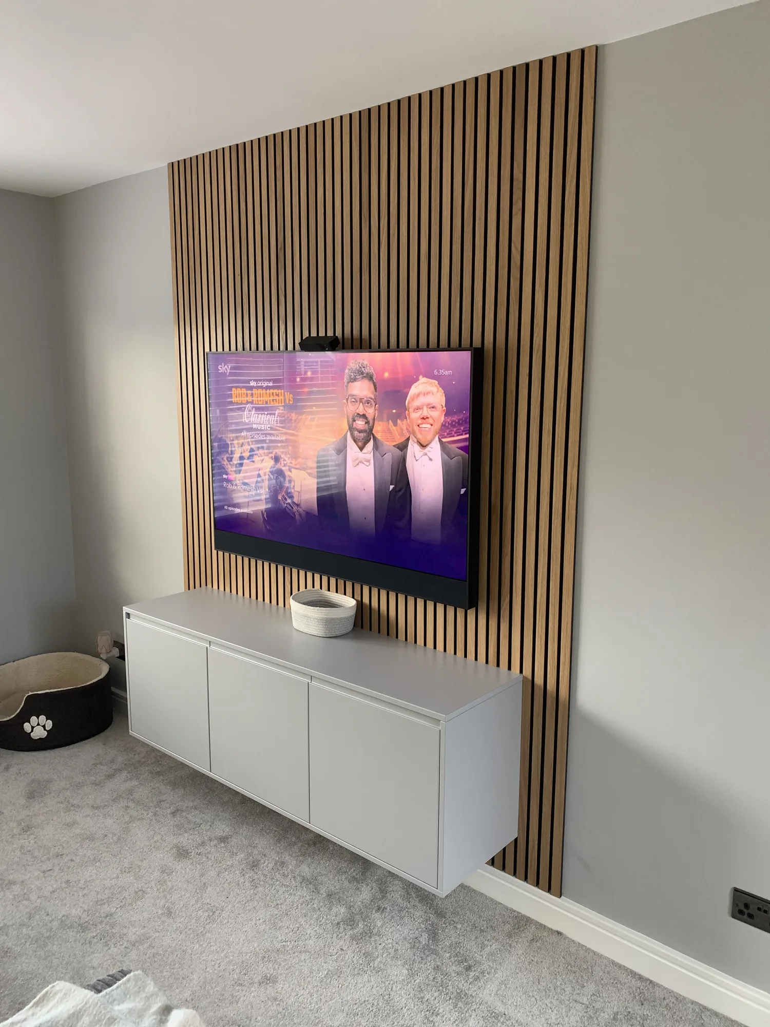 Wall-mounted floating white media cabinet by Chris Jones Joinery