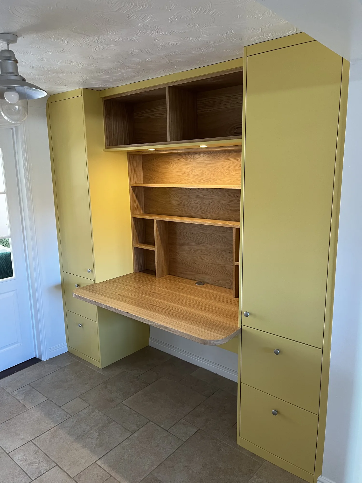 Full-wall fitted wardrobes finished in a soft neutral spray