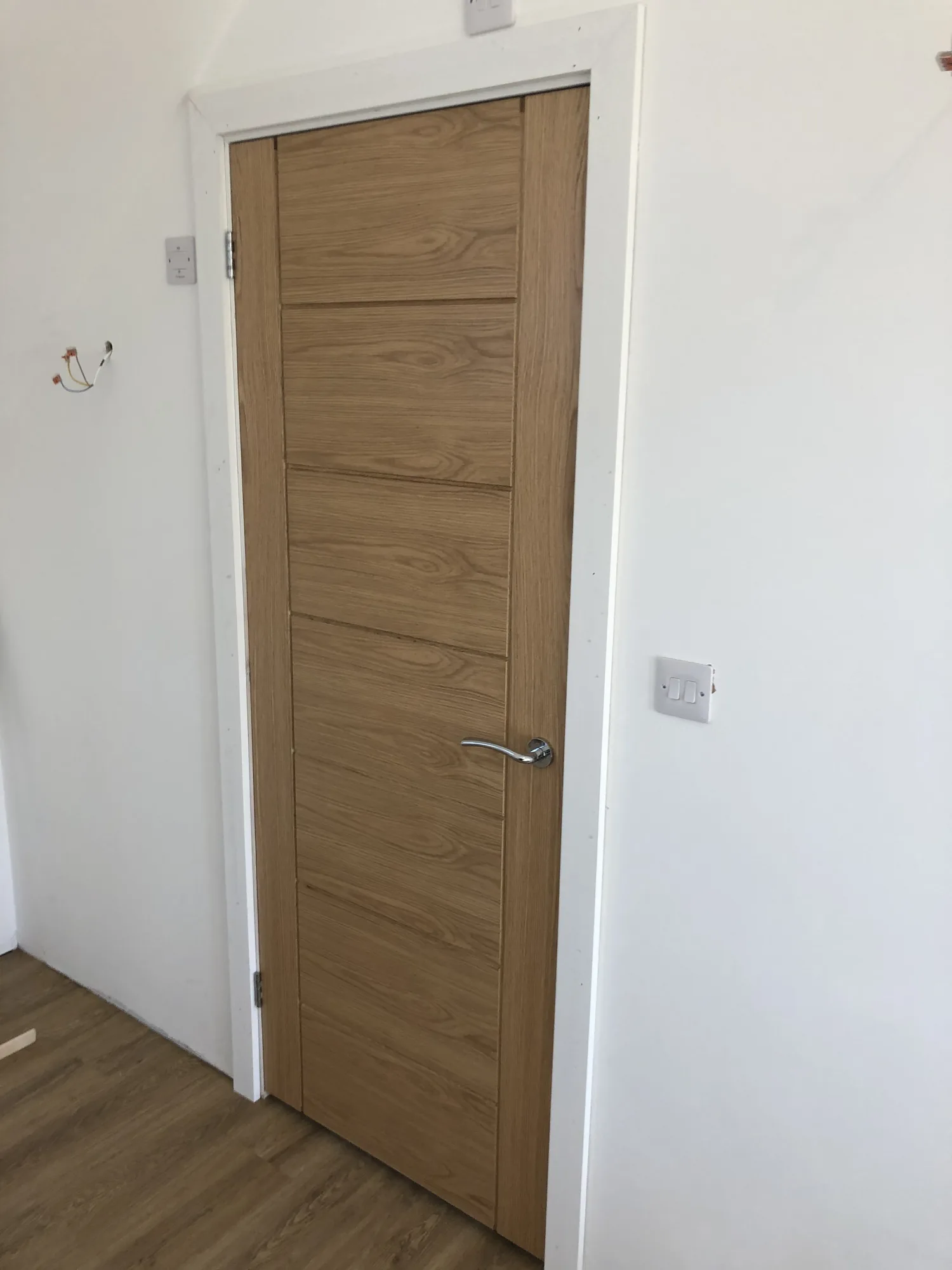 Solid oak door detail showing grain and quality ironmongery