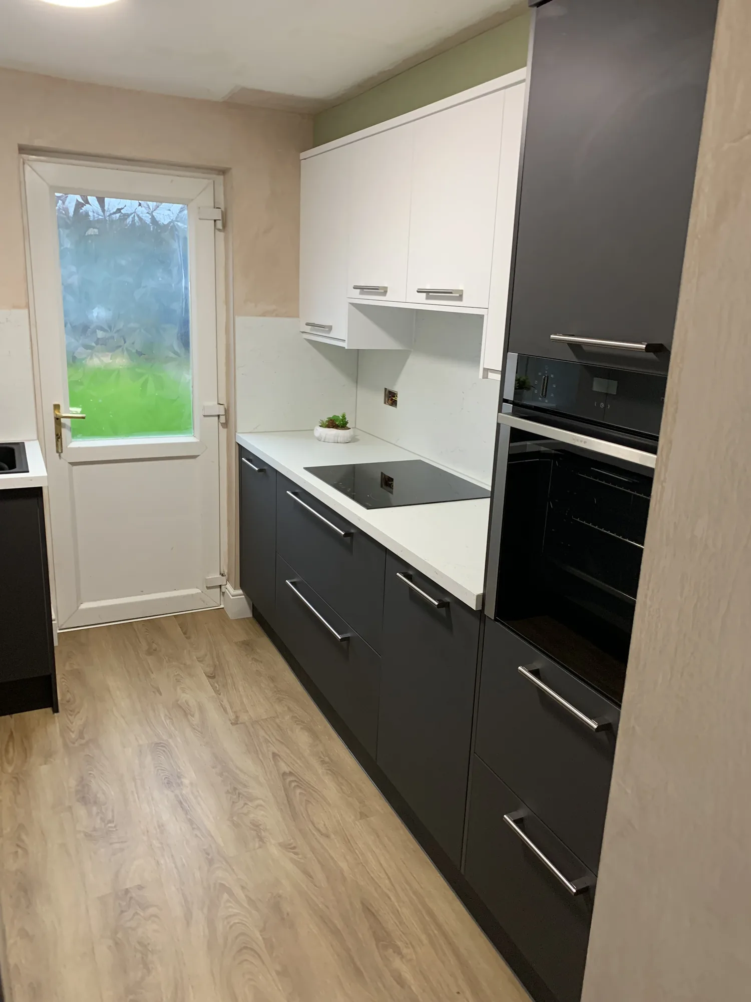 Kitchen alcove cabinetry with open shelving and downlights